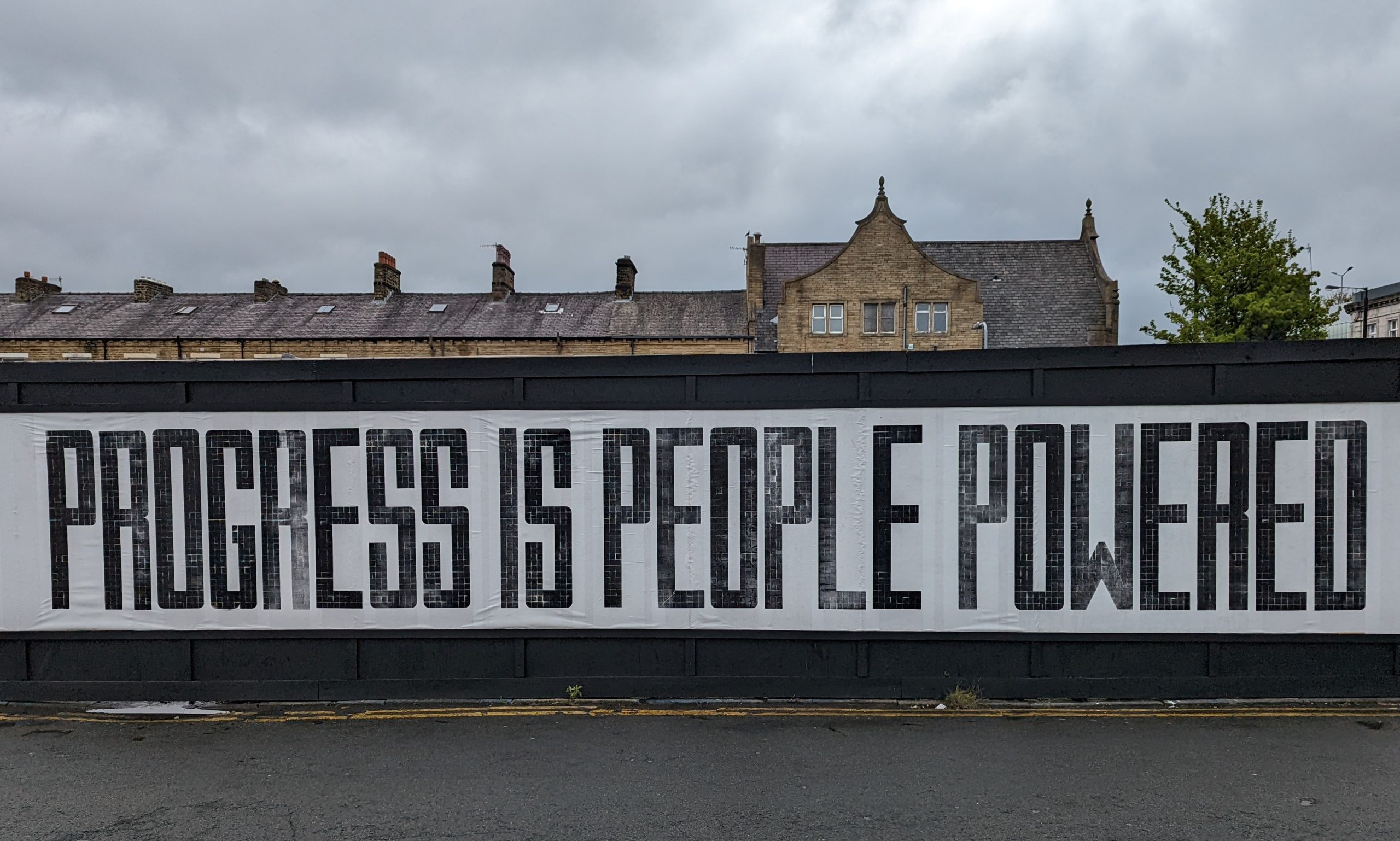 Mural reading 'Progress is People Powered'